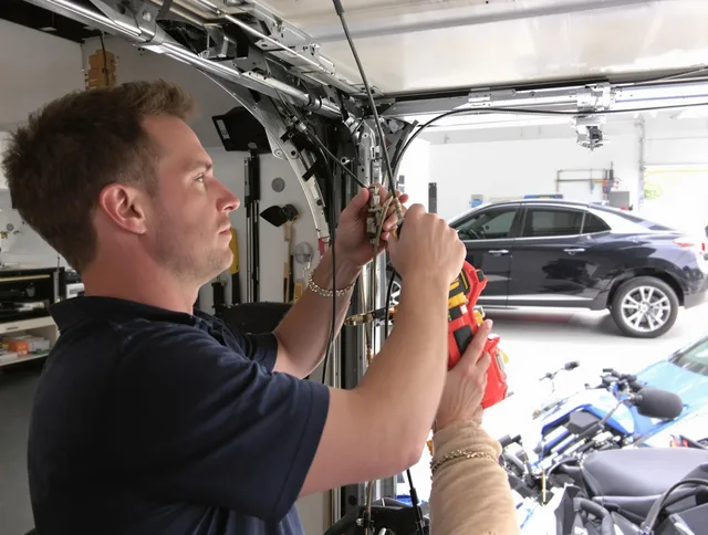 Newington Garage Door Repair safety certified technician performing cable replacement in Newington