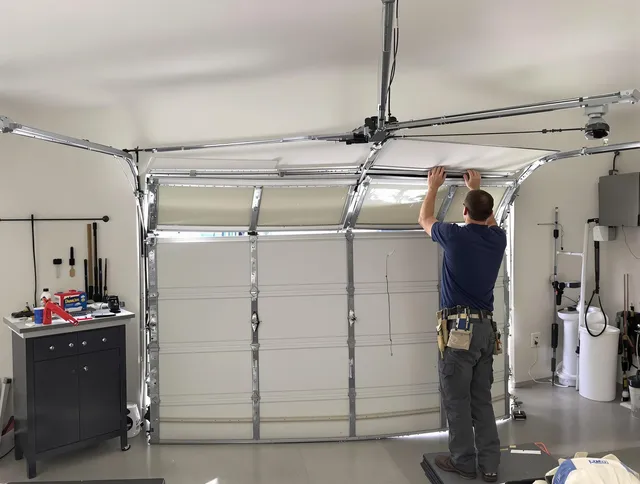 Newington Garage Door Repair specialist performing precise section replacement on Newington garage door